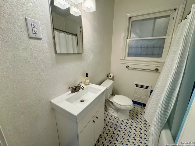 a bathroom with a sink toilet and mirror