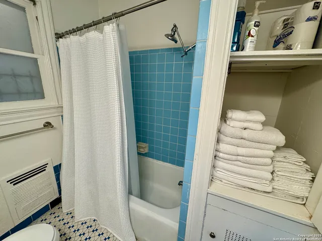 a bathroom with a shower and a sink
