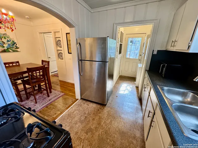 a kitchen with stainless steel appliances granite countertop a refrigerator and a stove top oven