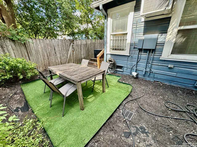a view of a backyard with chairs and a table