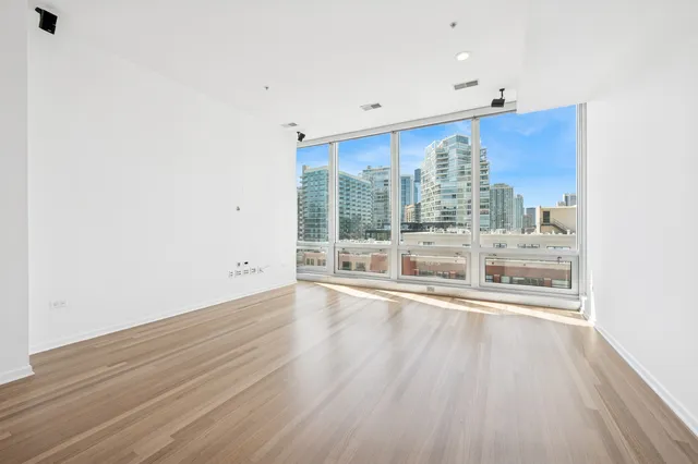 a view of a living room hardwood floor and chandelier
