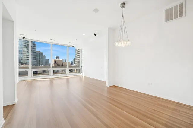 a view of a kitchen with wooden floor and a window