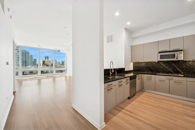 a kitchen with stainless steel appliances granite countertop a stove and cabinets