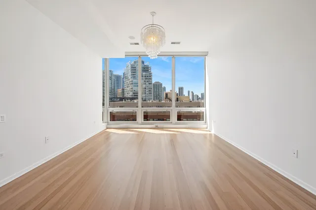 a view of a room with wooden floor and a window