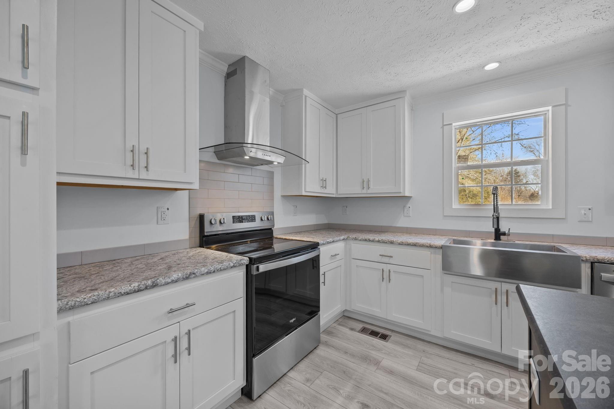 13190 Old Beatty Ford Road Rockwell, NC 28138 - Photo 12 of 23 a kitchen with granite countertop white cabinets and a sink
