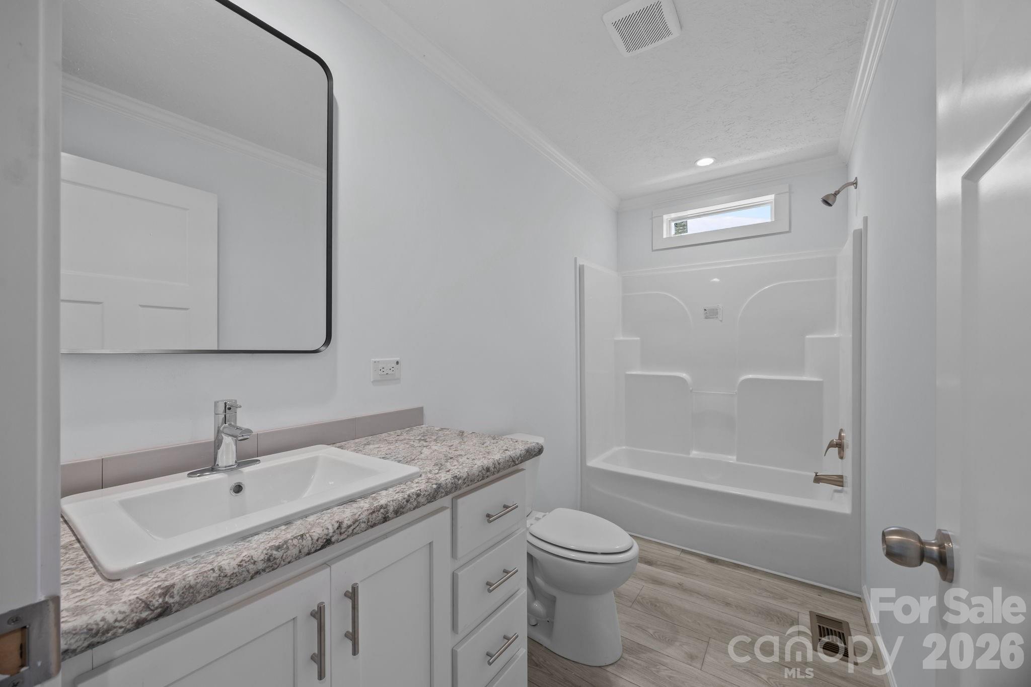 13190 Old Beatty Ford Road Rockwell, NC 28138 - Photo 19 of 23 a bathroom with a granite countertop sink a toilet and shower
