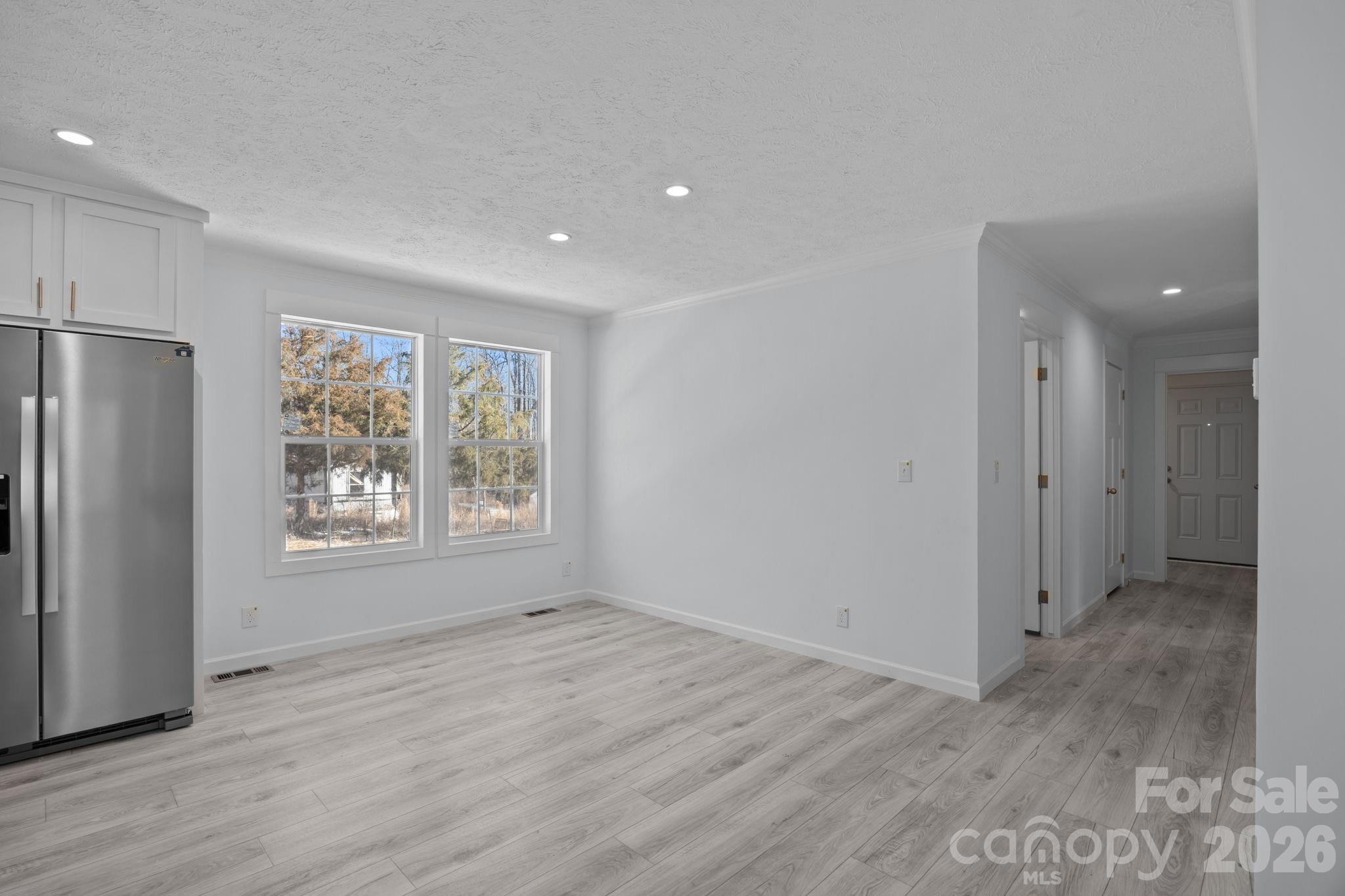 13190 Old Beatty Ford Road Rockwell, NC 28138 - Photo 20 of 23 a view of an empty room with wooden floor and a window