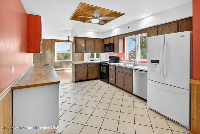 a kitchen with a sink a refrigerator and cabinets