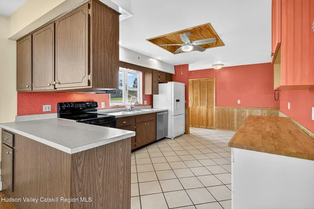 a kitchen that has a sink and a stove in it