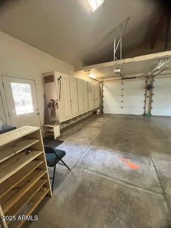 a living room with furniture a flat screen tv and large windows