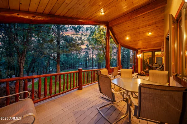 a kitchen with stainless steel appliances a sink a stove a refrigerator cabinets and living room view
