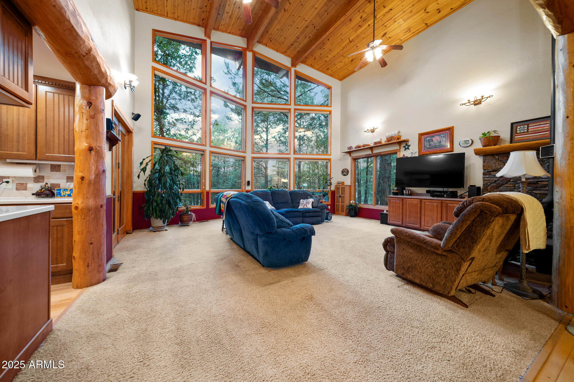 5468 Apache Trail Pinetop, AZ 85935 - Photo 27 of 73 a living room with furniture a flat screen tv and large windows