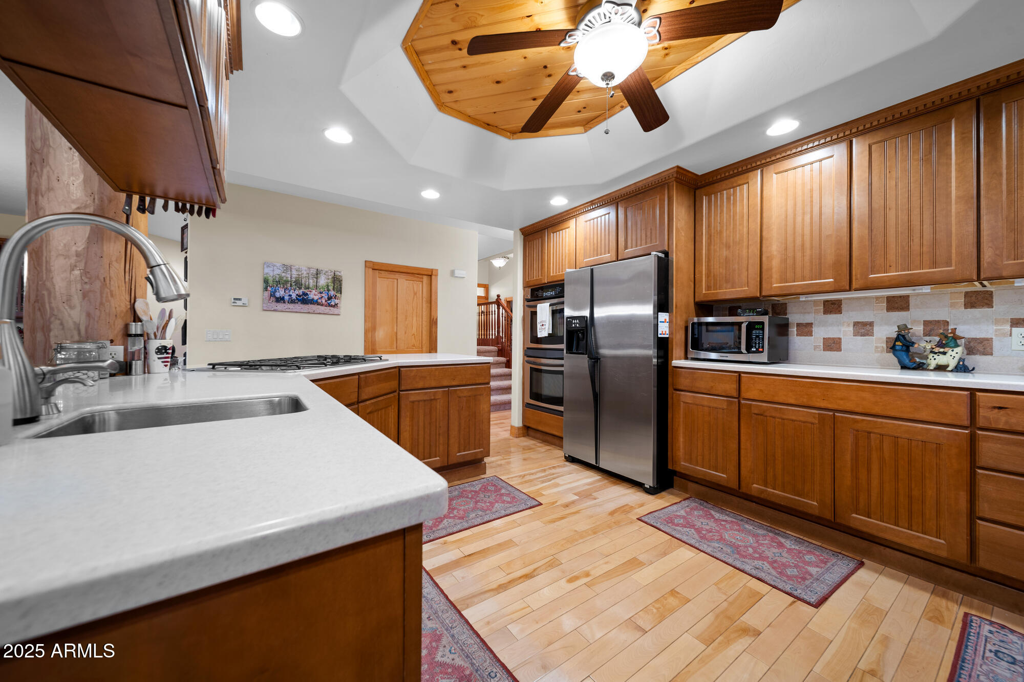 5468 Apache Trail Pinetop, AZ 85935 - Photo 32 of 73 a kitchen with stainless steel appliances a sink a stove a refrigerator cabinets and living room view