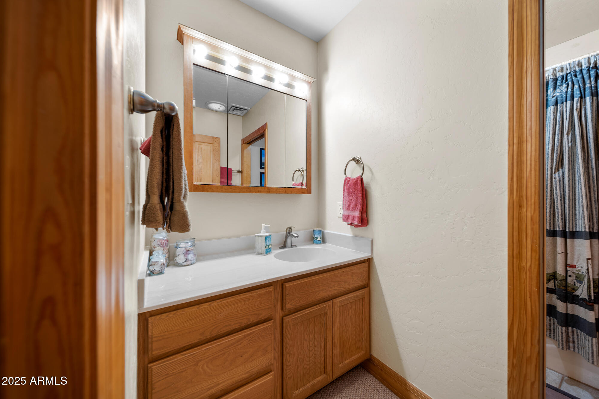 5468 Apache Trail Pinetop, AZ 85935 - Photo 50 of 73 a bathroom with a double vanity sink and a mirror