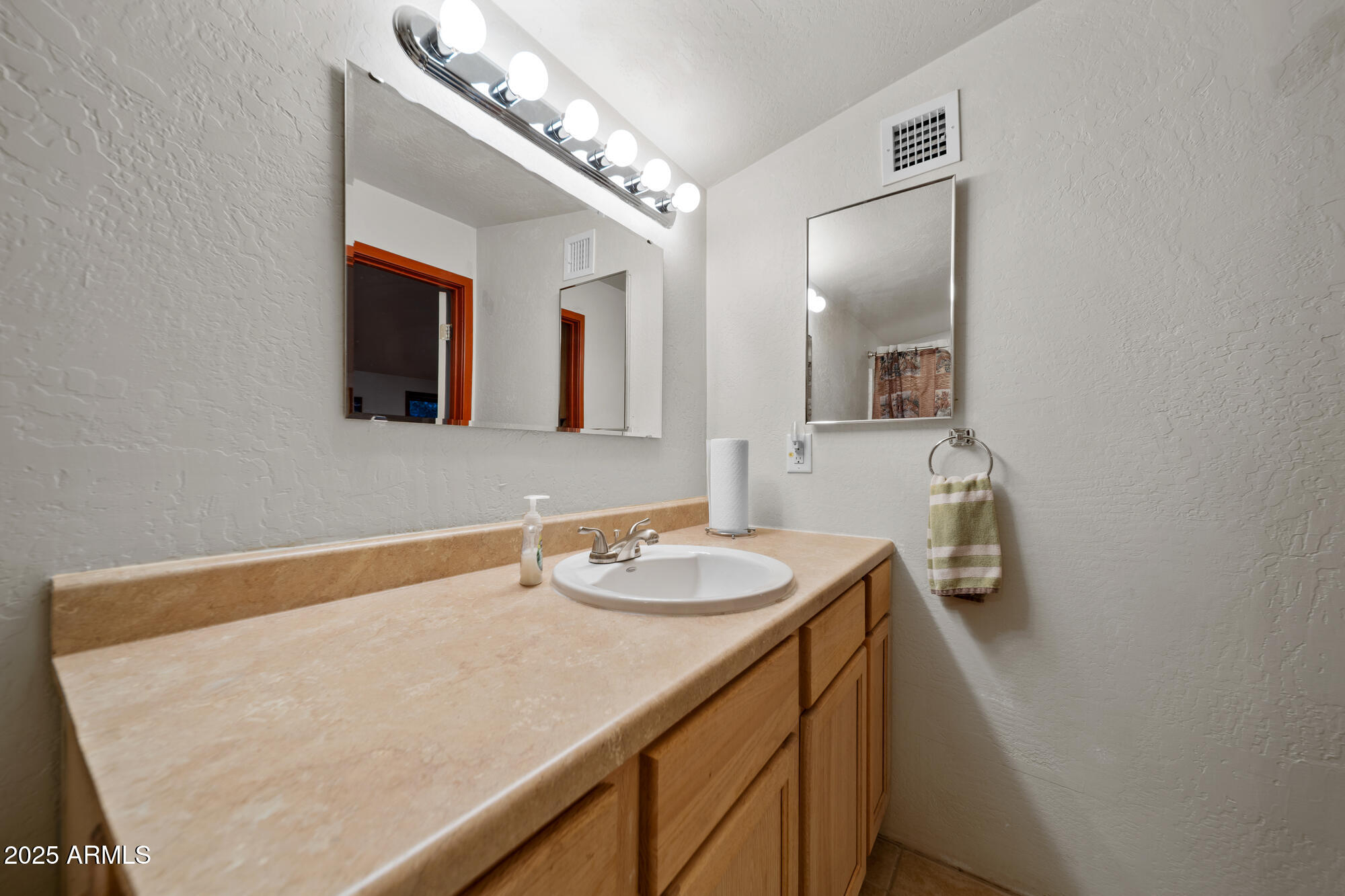 5468 Apache Trail Pinetop, AZ 85935 - Photo 66 of 73 a bathroom with a sink a vanity and mirror