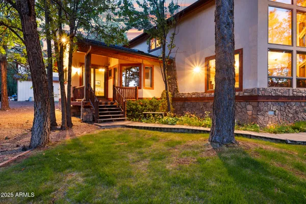a view of green field with trees in the background