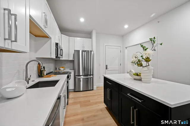 a kitchen with a sink appliances and cabinets