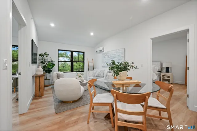 a dining room with furniture and wooden floor