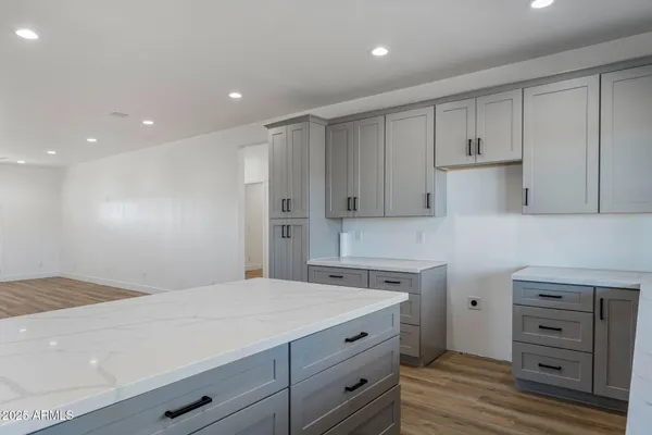 a kitchen with cabinets wooden floor and a sink