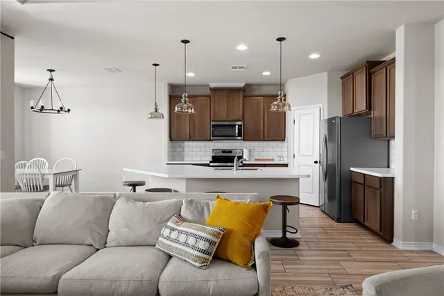 a living room with furniture and kitchen view
