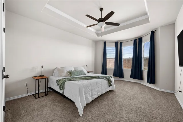 a bedroom with a large bed and a flat screen tv