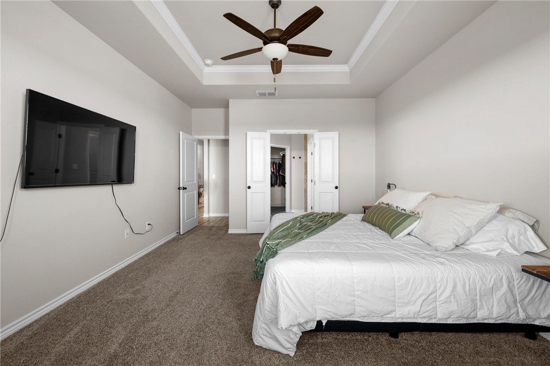 1035 Ocean Breeze Portland, TX 78374 - Photo 19 of 24 a spacious bedroom with a bed and a flat screen tv