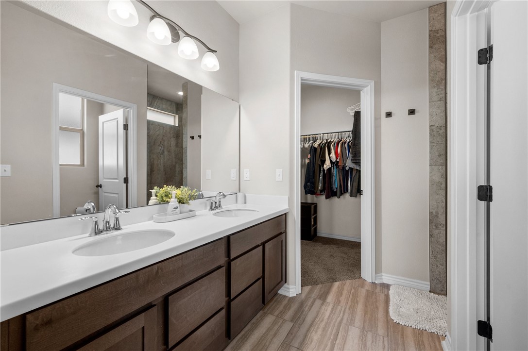 1035 Ocean Breeze Portland, TX 78374 - Photo 20 of 24 a en suite bathroom with a double vanity sink and a mirror