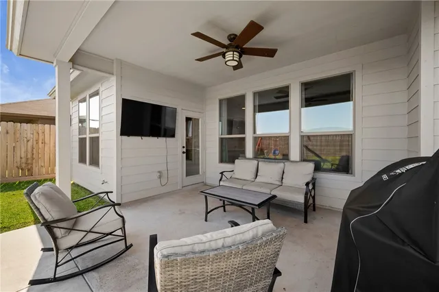 a backyard of a house with table and chairs