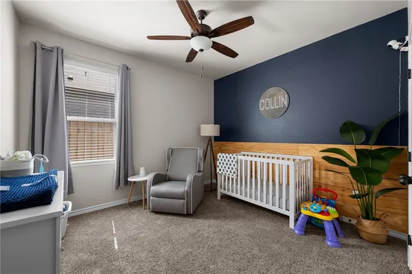 a living room with furniture a flat screen tv and a large window