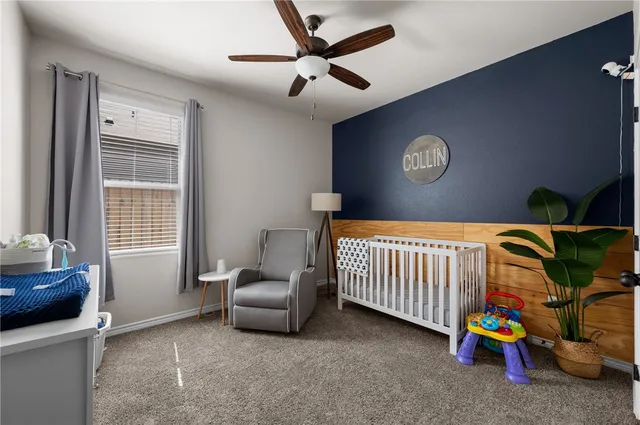 a living room with furniture a flat screen tv and a large window