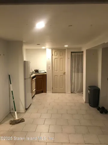 a view of a refrigerator in kitchen and living room