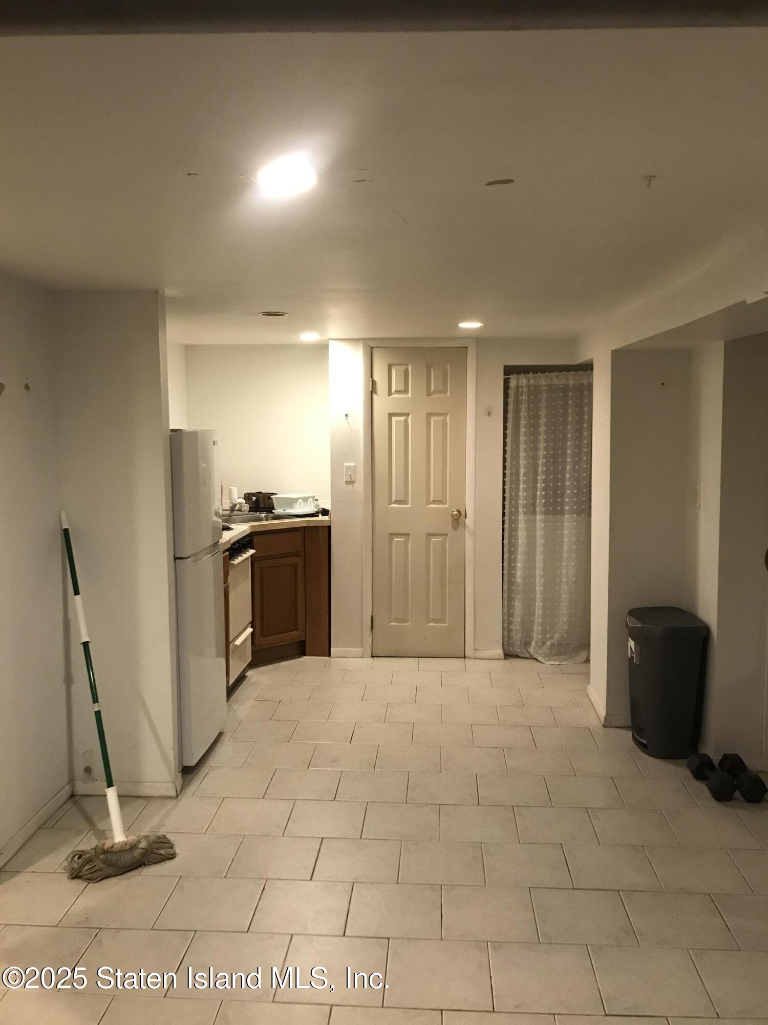 69 Narrows Road North Staten Island, NY 10305 - Photo 13 of 15 a view of a refrigerator in kitchen and living room