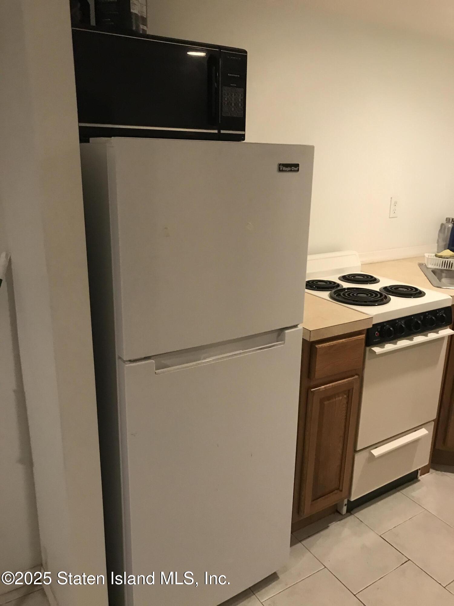 69 Narrows Road North Staten Island, NY 10305 - Photo 14 of 15 a close view of a stove top oven and washer