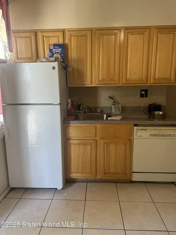 a kitchen with a refrigerator a stove a washer and dryer