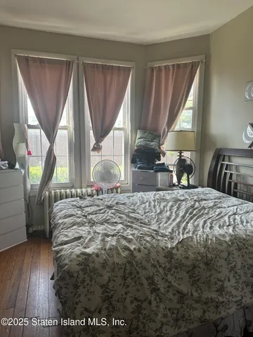 a bedroom with a bed a table and chair