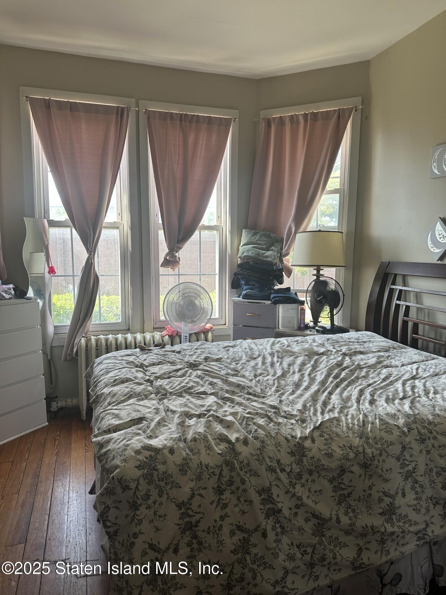 69 Narrows Road North Staten Island, NY 10305 - Photo 6 of 15 a bedroom with a bed a table and chair