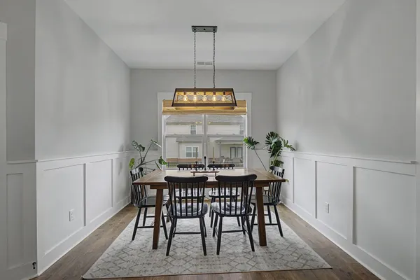 a view of a dining room with furniture window and wooden floor