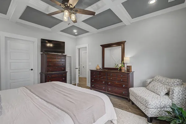 a bedroom with a bed and a television