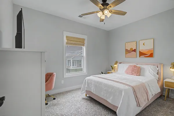 a bedroom with a bed and a chandelier