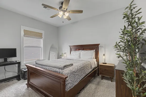 a bedroom with a bed and a chandelier