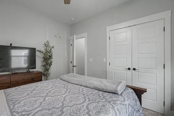 a bedroom with a bed and a flat screen tv