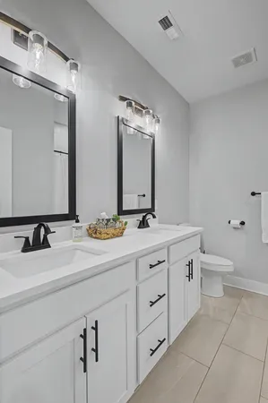 a bathroom with a double vanity sink and a mirror