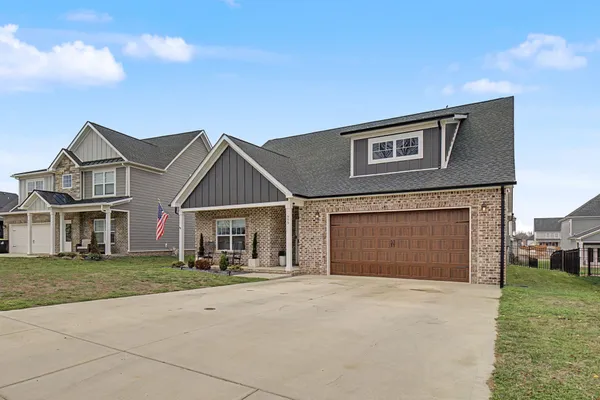a front view of a house with a yard and garage