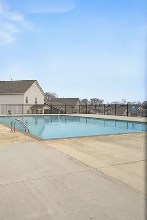 a view of swimming pool in front of residential houses
