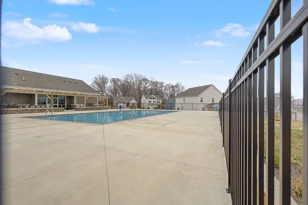 a view of house with tall trees in front of it