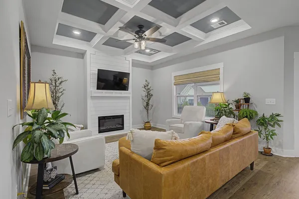 a living room with furniture a fireplace and a flat screen tv