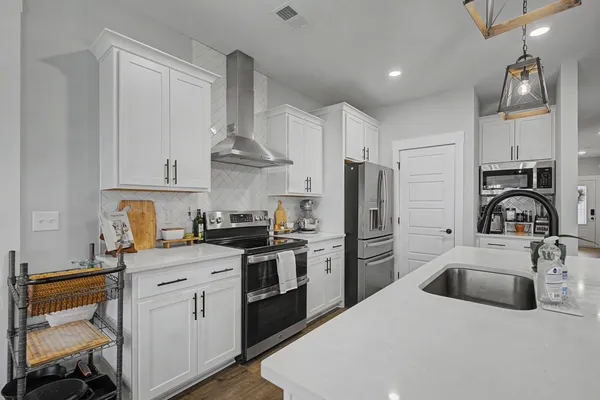 a kitchen with a sink a stove and refrigerator