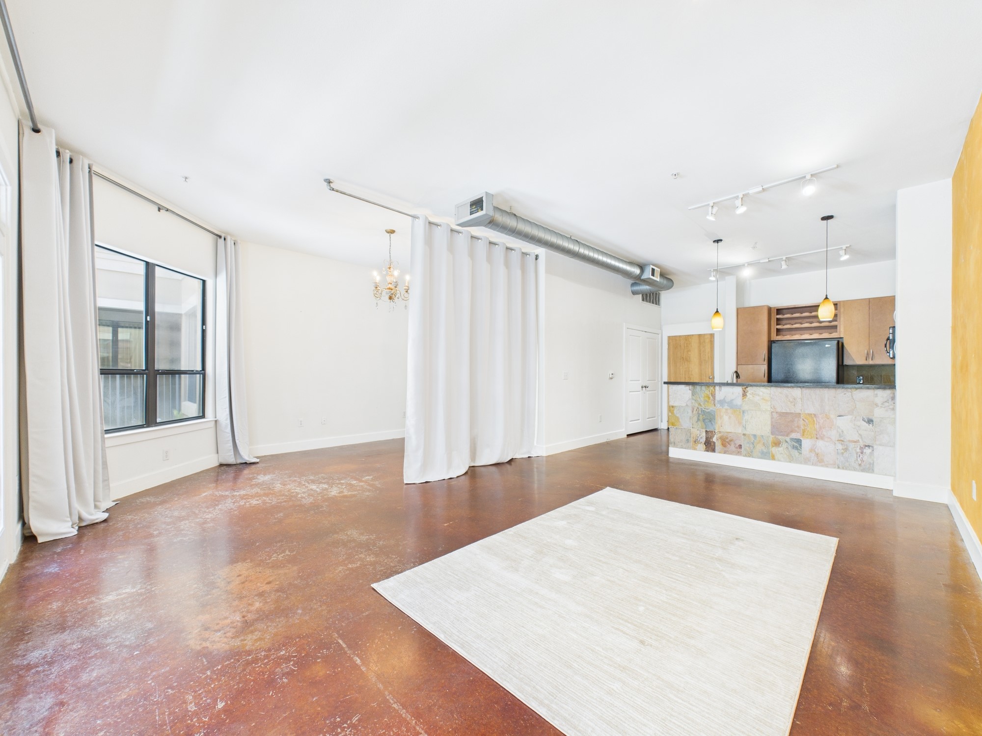 1901 Post Oak Boulevard, Unit 1405 Houston, TX 77056 - Photo 17 of 25 a large white kitchen with a large window