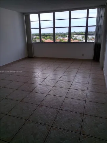 a view of an empty room with windows