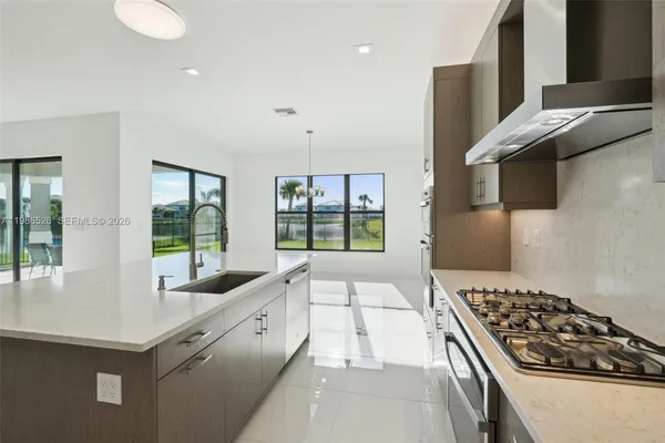 a large white kitchen with a large window